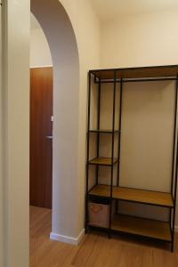 a room with a book shelf and an archway at Suite Home Reichenhall in Bad Reichenhall