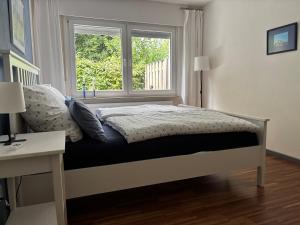 a bedroom with a bed and a window at Dorle`s Huus in Nordhorn