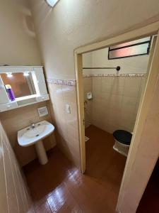 a small bathroom with a sink and a toilet at Quinta El Edén Studenko in Encarnación +21 photos
