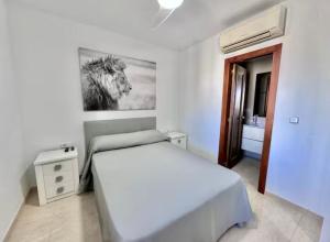 a bedroom with a bed and a picture of a horse at Bellaluz 18-16 La Manga Club in Atamaría +7 photos