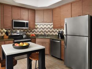 a kitchen with a refrigerator and a bowl of fruit on a table at Marriott Summit Watch 1BD in Park City +31 photos