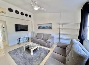 a living room with a couch and a table at Bellaluz 18-16 La Manga Club in Atamaría
