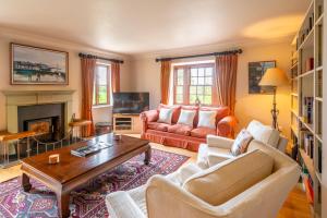 a living room with a couch and a table at Tuffon Hall Farmhouse 10 in Sible Hedingham