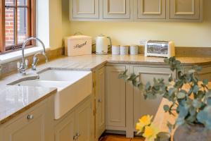 a kitchen counter with a sink and a toaster at Tuffon Hall Farmhouse 10 in Sible Hedingham +37 photos