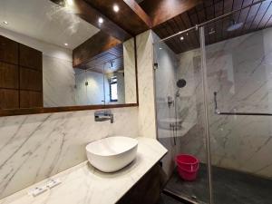 a bathroom with a sink and a shower at Hotel Akashdeep in Kolkata +64 photos