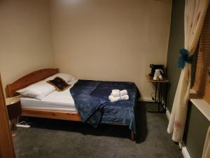 a bedroom with a bed with two towels on it at Teesside Haven in Middlesbrough in Middlesbrough