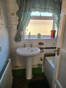 a bathroom with a sink and a window at Teesside Haven in Middlesbrough in Middlesbrough +7 photos