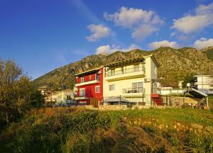 a building with a mountain in the background at SEMIRAMIS SUITES with pool in Kalamata