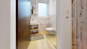 a bathroom with a toilet and a sink at Pension Rainer in Ellmau +40 photos