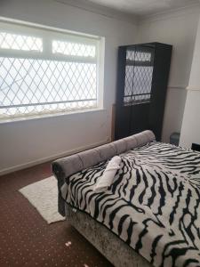 a zebra print bed in a room with a window at Teeside Port in Middlesbrough in Middlesbrough