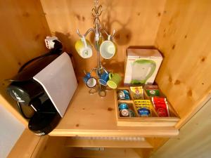 a wooden table with a shelf with a coffee pot and a tea kettle at La Perla di Pera in Pera
