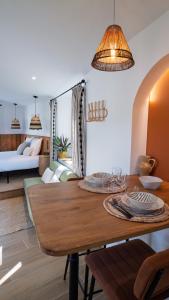 a dining room with a table and a living room at Le Pavillon - Les Lodges de Praly in Les Ollières-sur-Eyrieux +13 photos