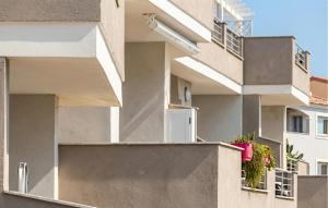 an apartment building with flowers on the balcony at Bilo Panorama in Castelsardo +8 photos