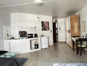 a kitchen and a living room with a table at popular condo c5 แม่ตัง in Thung Si Kan