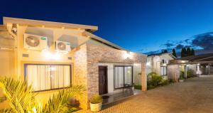 a house with lights on the side of it at Elle Apartments in Lusaka