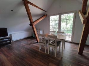 a dining room with a table and chairs at Bullerbü in Fincken