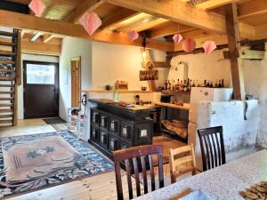 a kitchen with a stove and a refrigerator at Bullerbü in Fincken