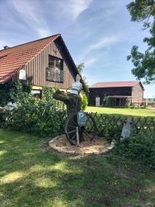 a statue of a water fountain in front of a house at Bullerbü in Fincken