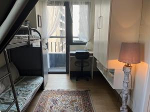 a room with a bed and a desk and a lamp at holiday with a maid in Sampong
