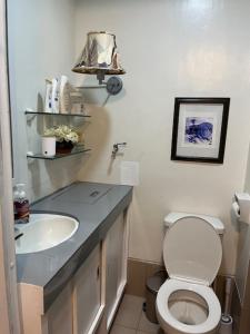 a bathroom with a toilet and a sink at holiday with a maid in Sampong