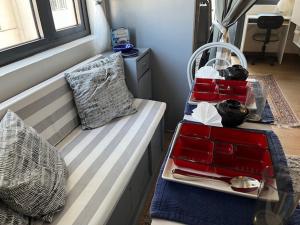 a bed with a tray of food on it at holiday with a maid in Sampong