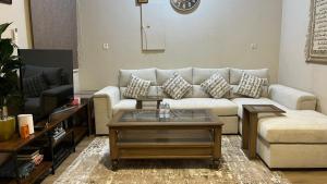 a living room with a couch and a coffee table at RUBA apartment in Dammam