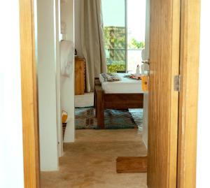 a bathroom with a sink and a desk with a window at La Perla Beach Resort, Zanzibar - Your Beachfront Private Haven in Pwani Mchangani
