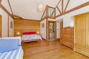 a bedroom with a bed and a dresser at Amber Lodge in Ashover