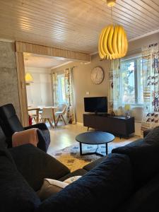 a living room with a couch and a table at Majoitus Eura in Kauttua