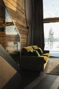 a living room with a couch and a large window at Jänkä Resort in Äkäslompolo