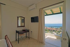 a bedroom with a view of the ocean at SEMIRAMIS SUITES with pool in Kalamata