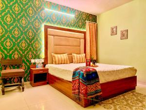 a bedroom with a bed and a chair in it at The Bay Leaf Resort in Shimla