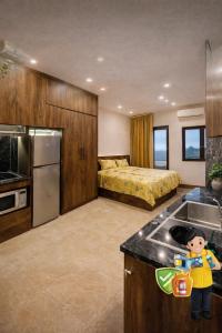 a room with a kitchen with a sink and a bed at May Home Hoalu in Phúc Trì