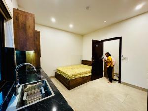 a woman taking a picture of a bedroom with a bed at May Home Hoalu in Phúc Trì