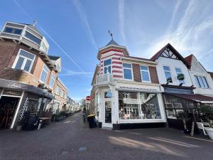 a group of buildings on a city street at Studio Strandkasteel, Free parking in Zandvoort