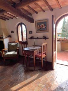 a dining room with a wooden table and chairs at Sunset and lake in Bolsena +30 photos