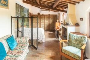 a living room with a bed and two chairs at Sunset and lake in Bolsena