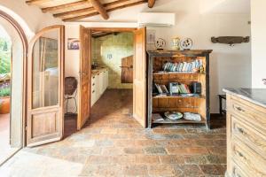 a kitchen with wooden cabinets and a book shelf at Sunset and lake in Bolsena