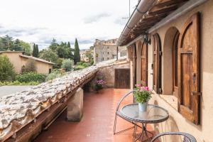 a patio with a table and chairs on a balcony at Sunset and lake in Bolsena