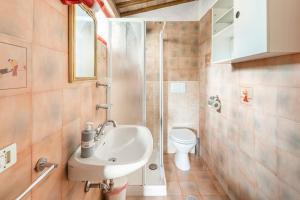 a bathroom with a sink and a shower and a toilet at Sunset and lake in Bolsena