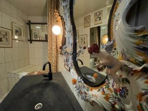 a bathroom with a sink and a mirror at Oranienburg Vintage Hotel - Private Garden Residence in Vianden +101 photos