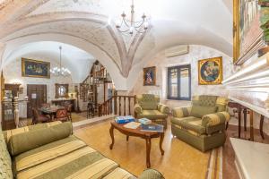 a living room with couches and a table at Casa Oasi del Mare in Gallipoli