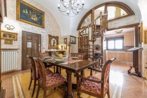 a dining room with a wooden table and chairs at Casa Oasi del Mare in Gallipoli