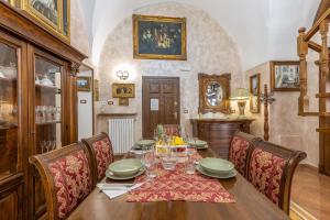 a dining room with a wooden table and chairs at Casa Oasi del Mare in Gallipoli +36 photos