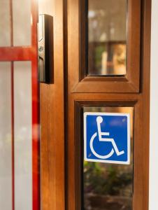 a sign on a door with a handicapped sign on it at Romaic Guesthouse Welkom in Welkom
