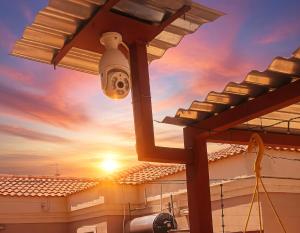 a light on a building with the sunset in the background at Romaic Guesthouse Welkom in Welkom