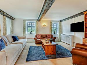 a living room with a couch and a table at 6 Bed in Taunton oc-95371 in Bicknoller