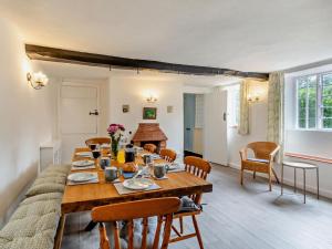 a dining room with a long wooden table and chairs at 6 Bed in Taunton oc-95371 in Bicknoller