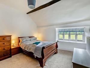 a bedroom with a bed and a dresser and a window at 6 Bed in Taunton oc-95371 in Bicknoller