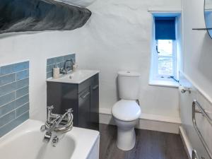 a bathroom with a toilet and a sink and a tub at 6 Bed in Taunton oc-95371 in Bicknoller +24 photos